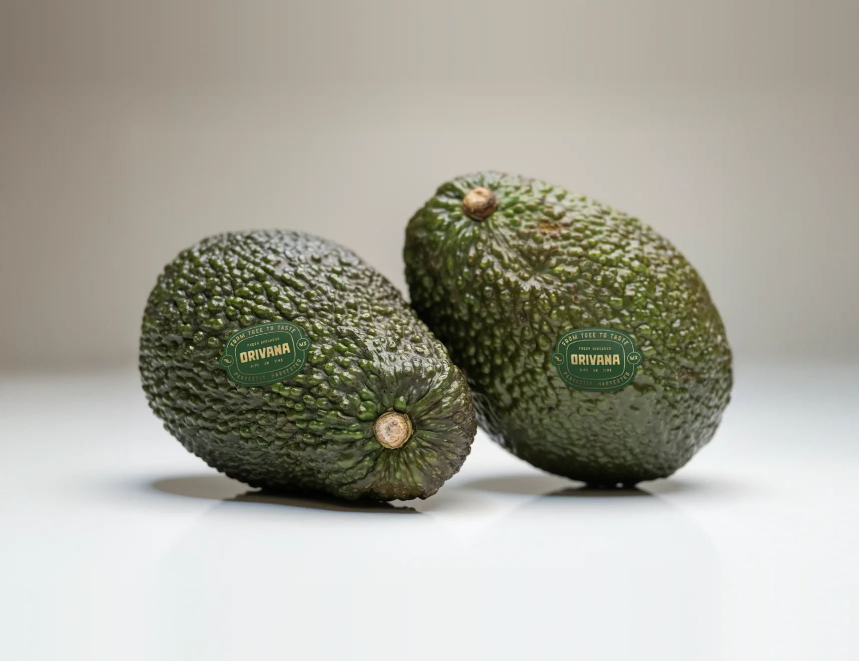 Two Hass avocados with the ORIVANA label